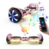 A pink camouflage hoverboard H2 with glowing blue wheel lights and yellow underglow is shown alongside a smartphone displaying a music app. Colorful musical notes are illustrated, suggesting a Bluetooth connection for playing music.