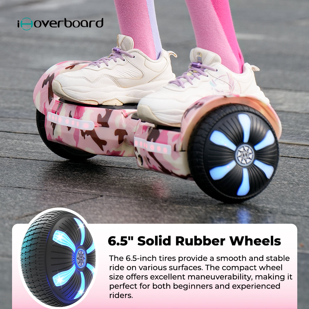 A person in white sneakers rides the iHoverboard Hoverboard for Kids Aged 6+ (Self Balancing, Bluetooth, LED 6.5"-H2) in pink camouflage with glowing blue wheels. An inset highlights its stable, illuminated tire. A person in white sneakers rides the iHoverboard Hoverboard for Kids Aged 6+ (Self Balancing, Bluetooth, LED 6.5"-H2) in pink camouflage with glowing blue wheels. An inset highlights its stable, illuminated tire.