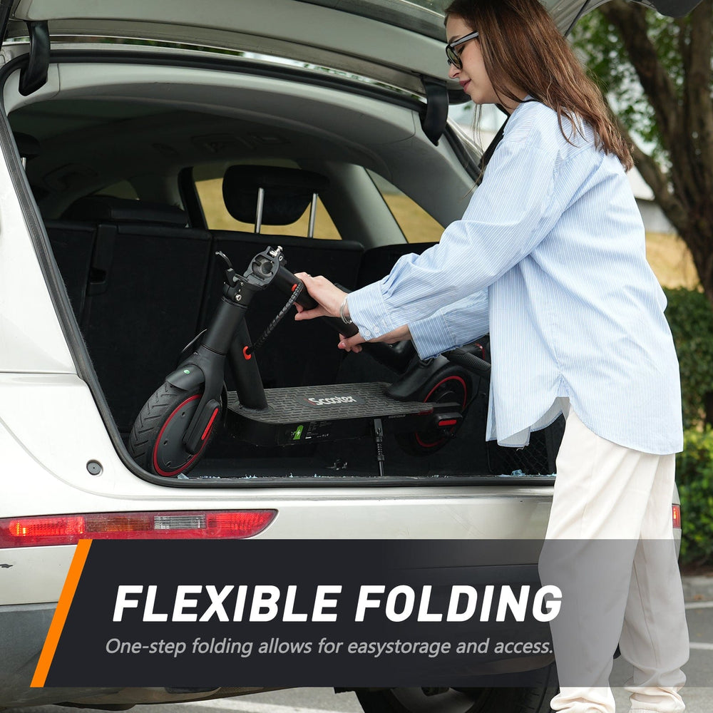 A person in a blue shirt places a folded black electric scooter with red accents into the trunk of a white car, highlighting the scooter's easy storage feature.