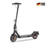 A sleek black electric scooter E9pro with a sturdy frame and red accents stands against a plain background, featuring a textured foot deck and compact wheels. The "ABE Approved" logo with a German flag is displayed in the top right corner.