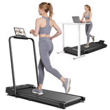 A woman in gray athletic wear runs on a black treadmill jt51 with a tablet mounted on the handle, while another treadmill is set up under a white desk where a second woman types on a laptop.