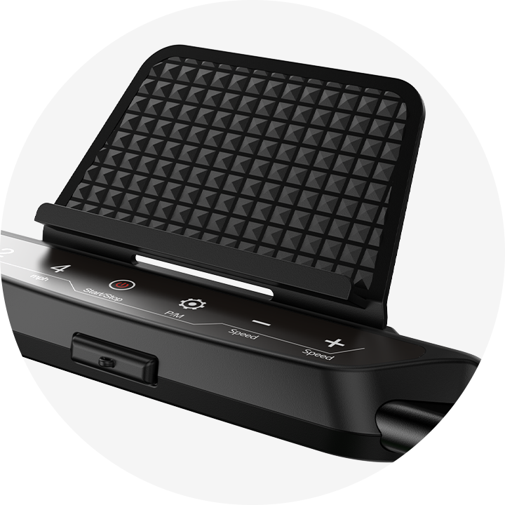 A close-up of a treadmill JT51 control panel with a textured black phone holder above it. The panel features buttons for start/stop, speed adjustment, and other functions, set against a sleek black surface.