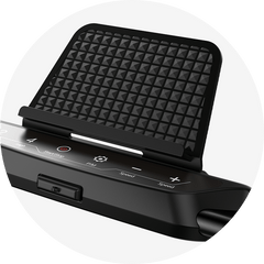 A close-up of a treadmill JT51 control panel with a textured black phone holder above it. The panel features buttons for start/stop, speed adjustment, and other functions, set against a sleek black surface.