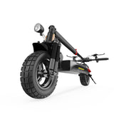A sleek black electric scooter is folded, showcasing its sturdy front wheel with a prominent tread, dual suspension, and a mounted headlight. The handlebar and rear wheel are visible, highlighting the scooter's compact and practical design.