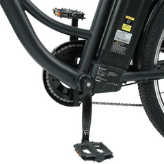 Close-up of an electric bike's central frame showing the black battery pack, pedal, and chain mechanism, with visible labels and a sturdy black finish.