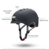 A sleek black helmet featuring multiple vents, a front headlight, and a rear taillight for visibility. It has an impact-resistant housing and a convenient buckle for easy fastening.