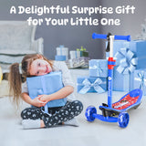 A young girl joyfully hugs a blue gift box while sitting on the floor, surrounded by more blue presents with ribbons. Beside her, a colorful children's scooter minispider with blue handlebars and wheels is prominently displayed.