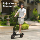 A man wearing a helmet rides an electric scooter ix7pro on a paved path in front of a house with lush greenery and classic architecture, with the words "Enjoy Your Commute" displayed above.