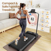 A woman jogs on a compact, foldable treadmill JT51 in a cozy living room setting, wearing a gray sports bra and black leggings. The treadmill features a digital display showing her speed and distance, with a couch and decorative items in the background.