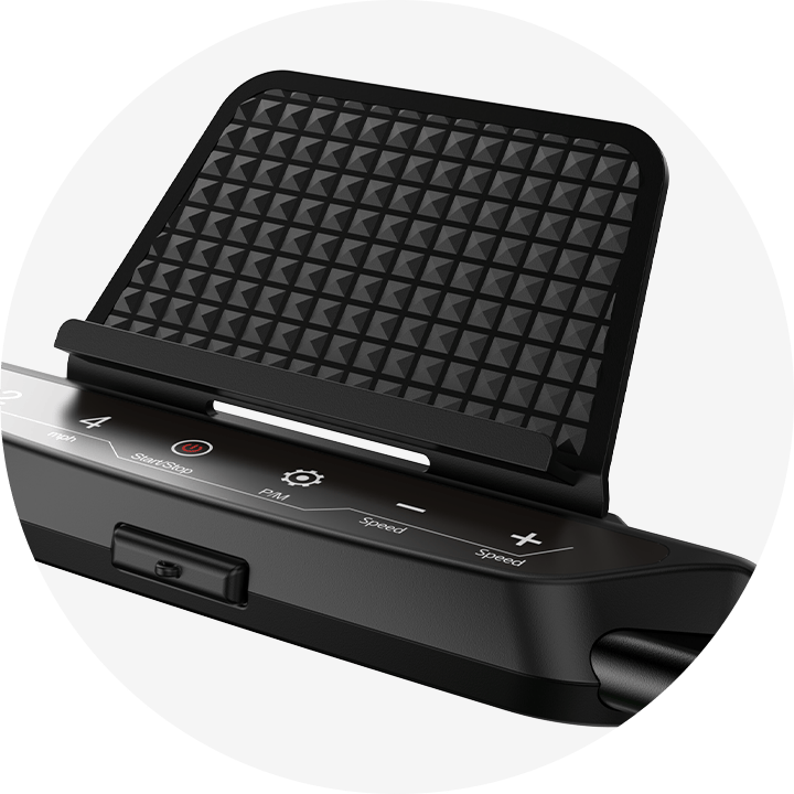 A close-up of a treadmill JT51 control panel with a textured black phone holder above it. The panel features buttons for start/stop, speed adjustment, and other functions, set against a sleek black surface.