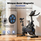 A sleek stationary bike QK116C with a black and blue design stands in a sunlit room, featuring a whisper-quiet magnetic flywheel. The bike highlights a dual-triangle frame for stability and a capacity weight of 130kg, promising a smoother, quieter riding experience.