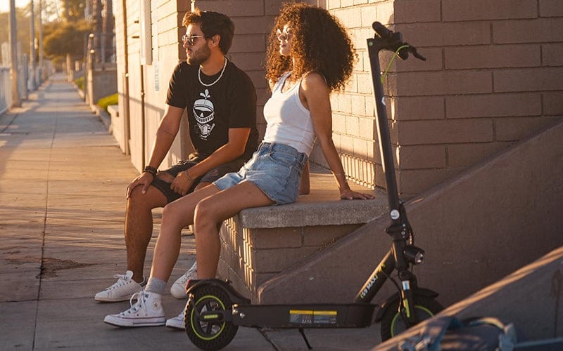 two people and a electric scooter