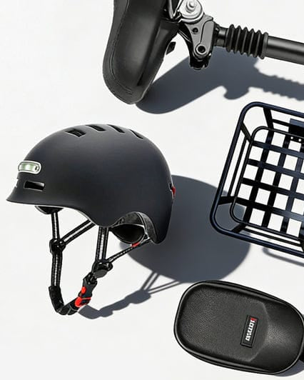 A collection of electric scooter accessories is displayed on a light background, featuring a black helmet, a small cargo basket, a coiled combination lock, a compact storage pouch, and a scooter handlebar.