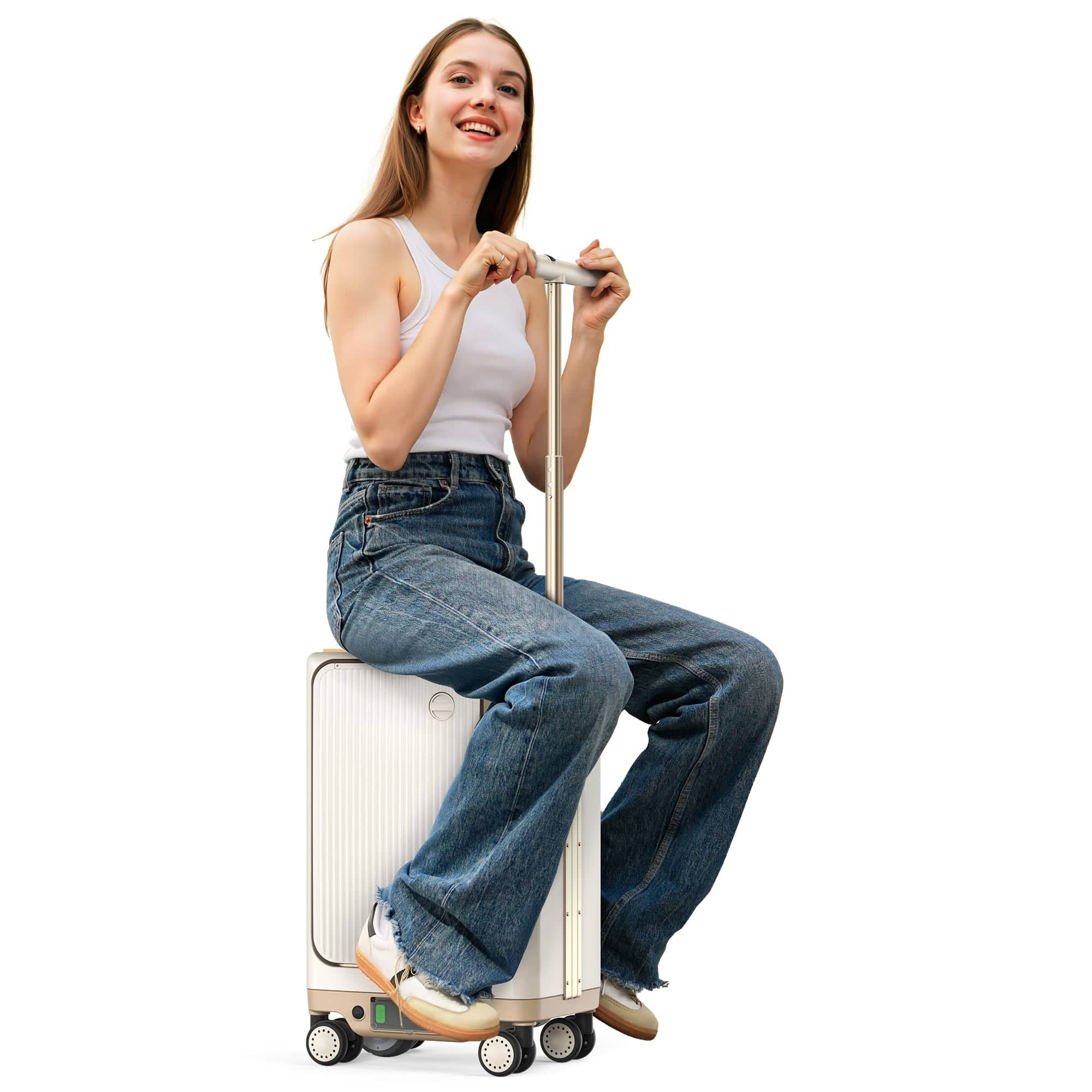 A young woman sitting on a modern suitcase, smiling and holding the handle. She is wearing a white tank top and loose denim jeans, with a playful expression, and is positioned against a plain background.
