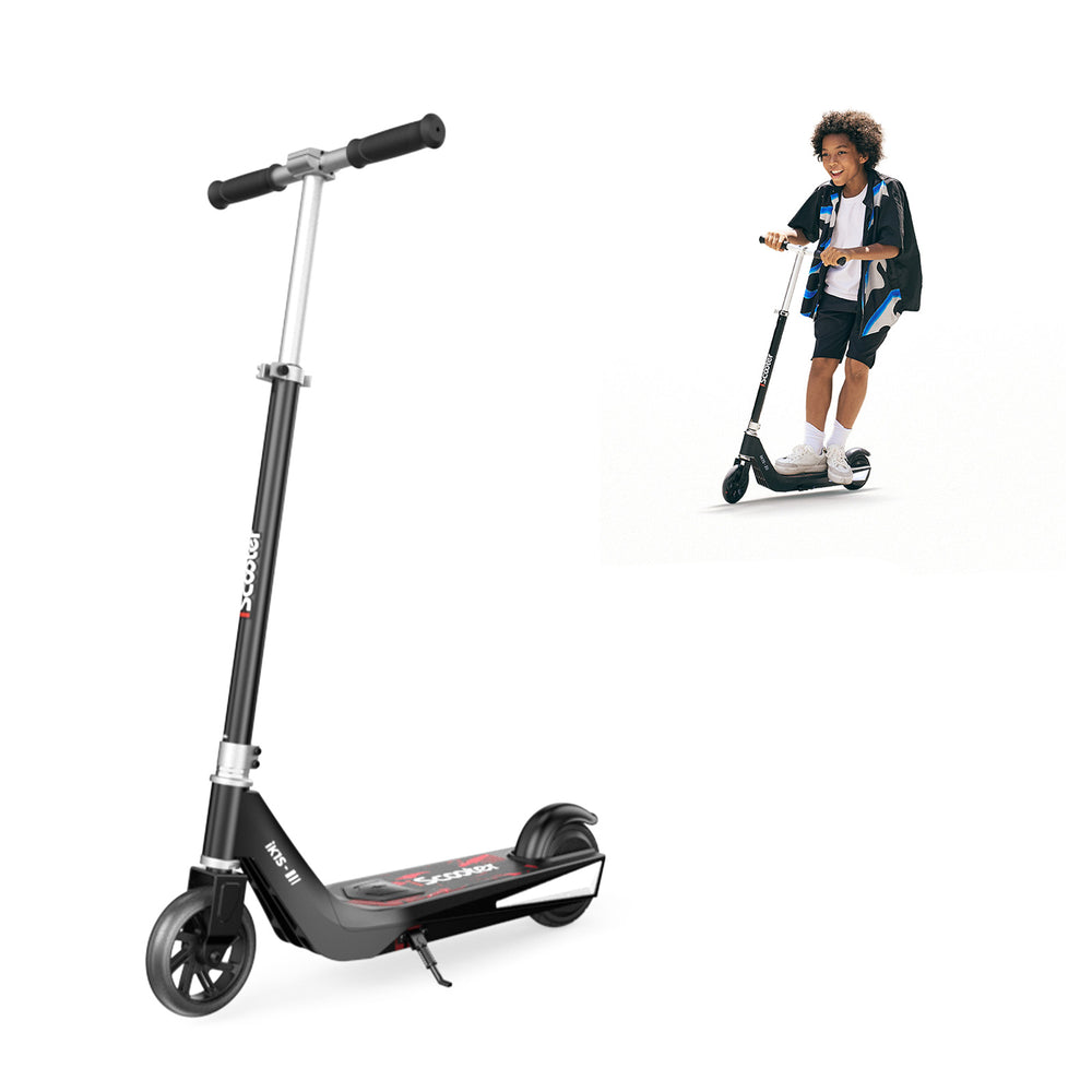 A sleek black electric scooter ik1s
with a sturdy frame and large wheels is shown, featuring a kickstand and the brand name "iScooter" on the deck. In the background, a young person is joyfully riding a similar scooter, wearing casual clothing and sneakers.