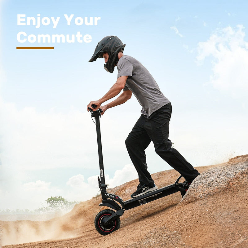 A person wearing a helmet rides a black electric scooter ix7pro up a dirt hill under a clear blue sky, with the text "Enjoy Your Commute" in the background.