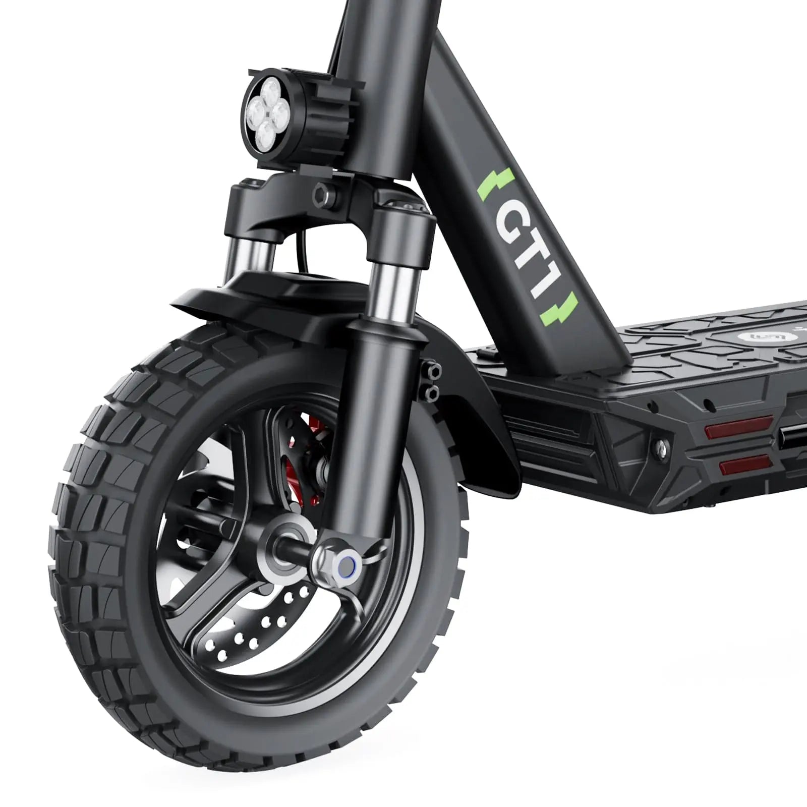 Close-up of an GT1 electric scooter's front wheel featuring a rugged tire, disc brake, and a dual LED headlight mounted above. The frame is marked with "GT1" in green, and the deck has a textured surface for grip.