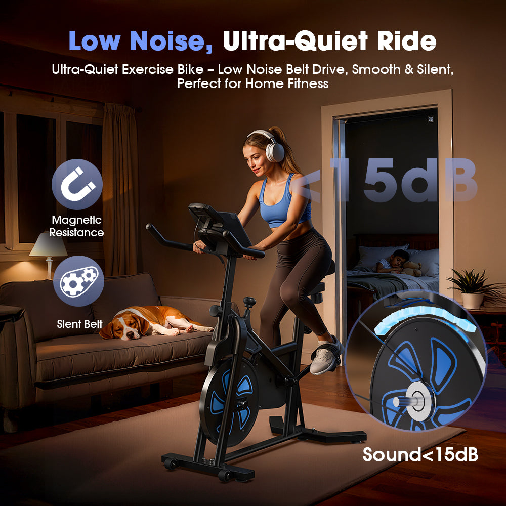 A woman wearing headphones exercises on a stationary bike QK116C in a cozy living room, while a dog sleeps on a nearby sofa. The bike features a low-noise belt drive and magnetic resistance, with sound levels under 15dB, ideal for quiet home fitness.