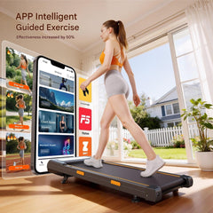A woman exercises on a sleek treadmill in a bright room with large windows showing a sunny backyard. She wears an orange sports top and gray shorts. Next to her, a large virtual display showcases various fitness app options, including training, walking, and workout music.